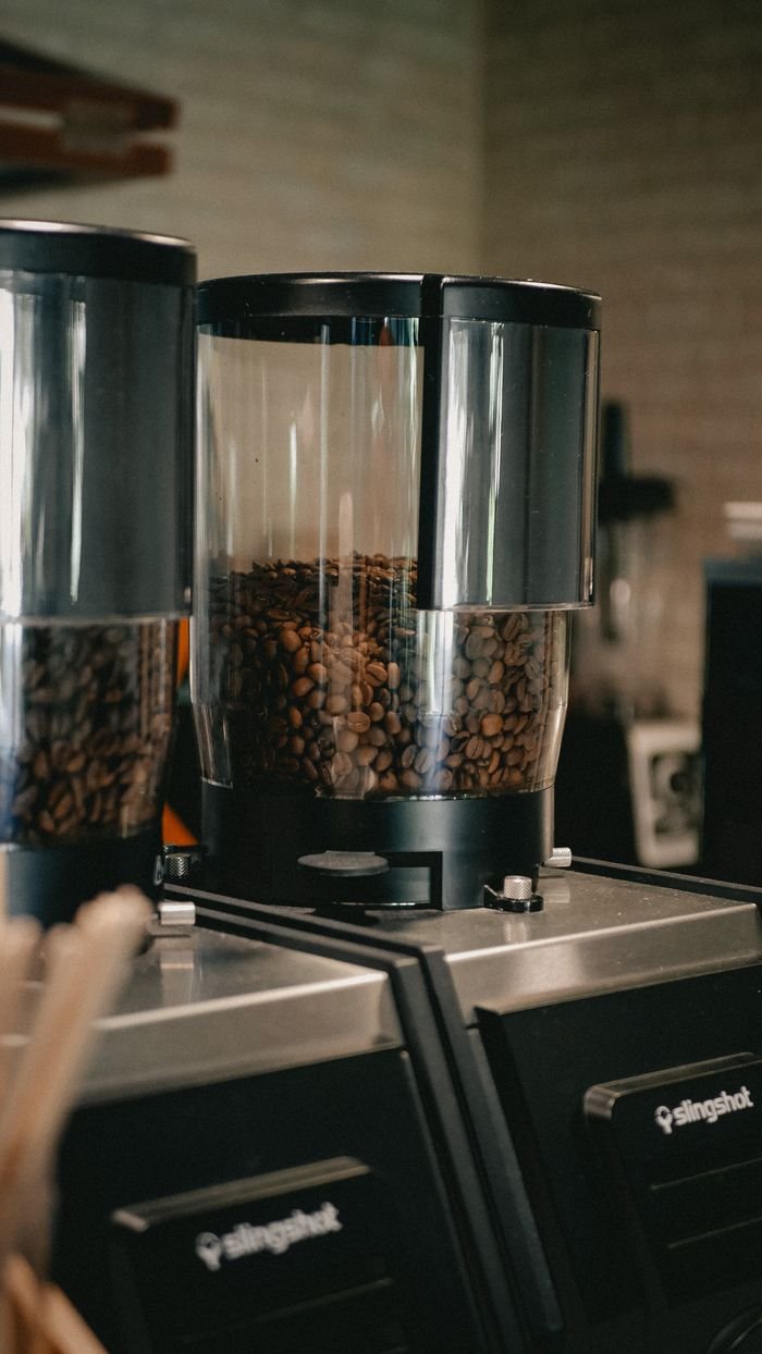 services-04 Coffee beans in a grinder at a café, perfect for a fresh brew.