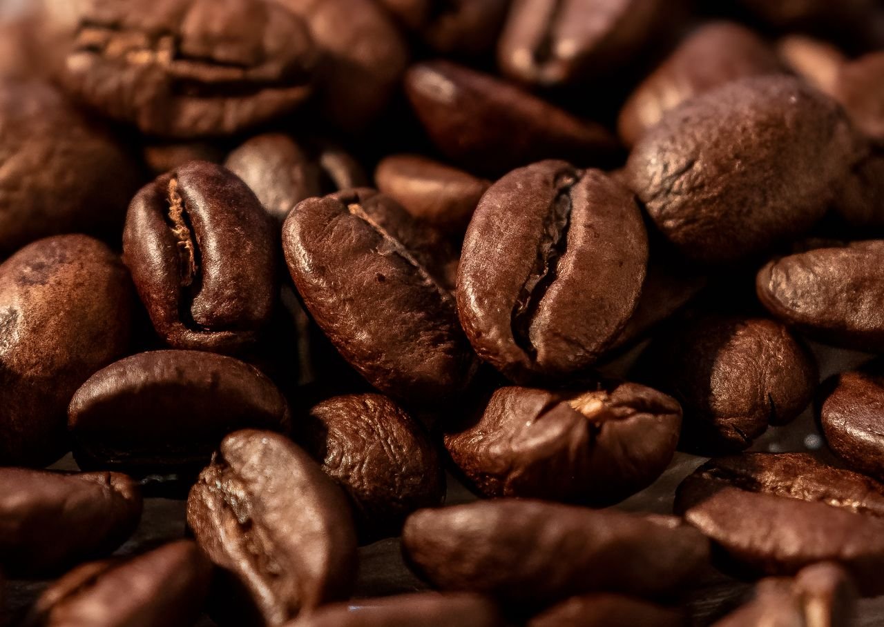 services-01 Close-up macro image of roasted brown coffee beans for a rich aroma.
